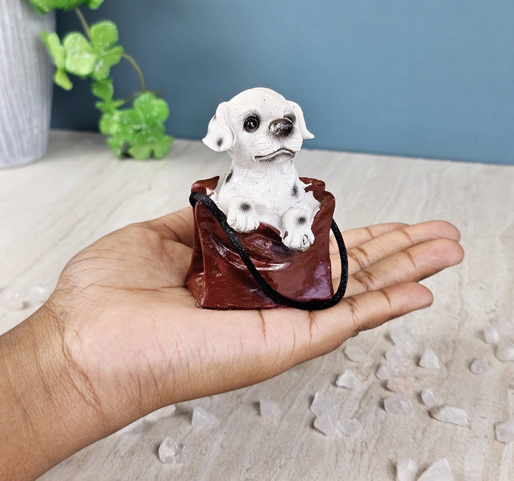 1 pc Cute Miniature Dog in Bag Poly Resin Statue with Hanging, Decorative Piece for Living Room, Bed Room, Table top, Restaurant, cafes, Gifting, Birthday( Pack of 1)