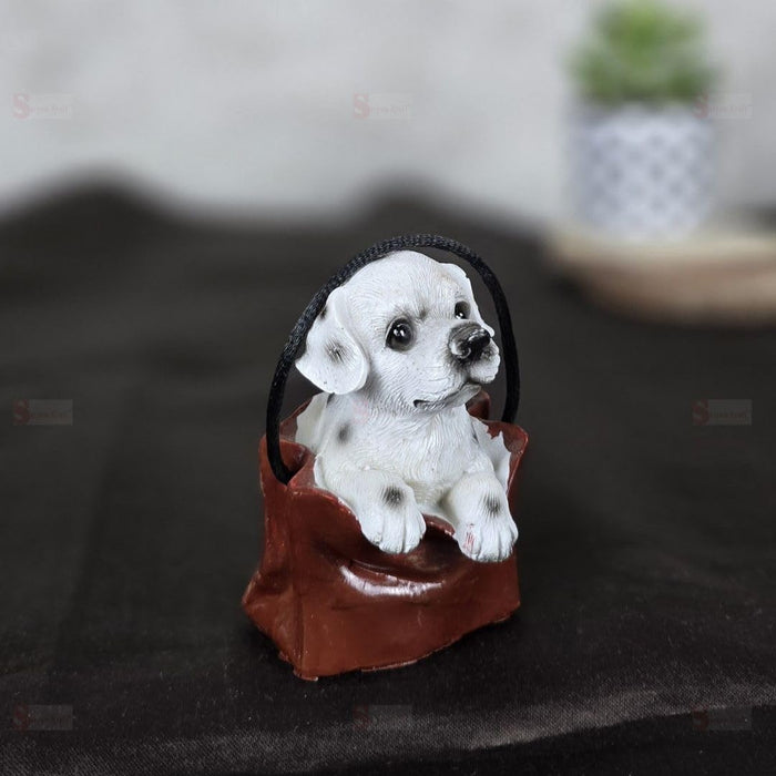 1 pc Cute Miniature Dog in Bag Poly Resin Statue with Hanging, Decorative Piece for Living Room, Bed Room, Table top, Restaurant, cafes, Gifting, Birthday( Pack of 1)