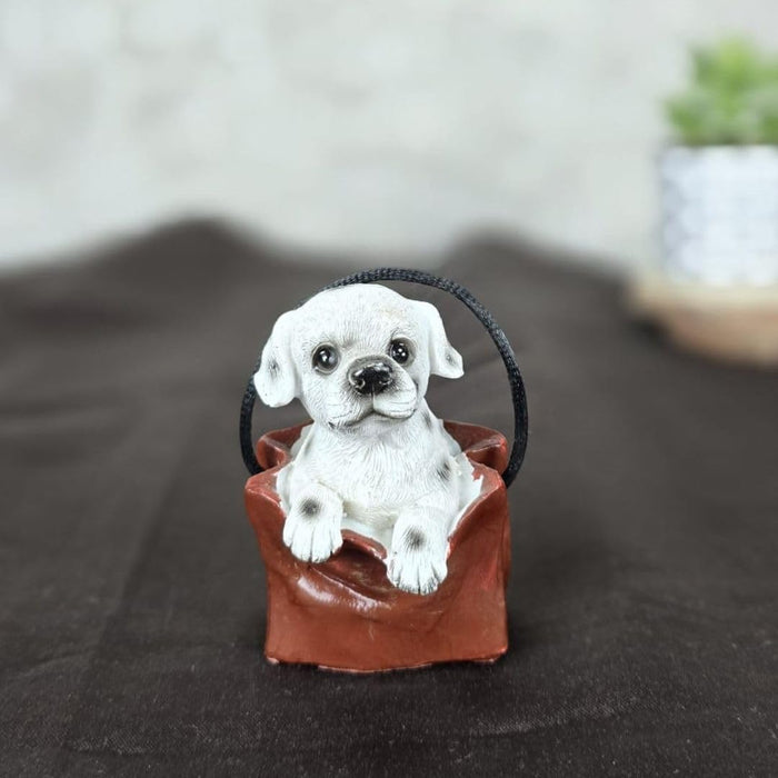 1 pc Cute Miniature Dog in Bag Poly Resin Statue with Hanging, Decorative Piece for Living Room, Bed Room, Table top, Restaurant, cafes, Gifting, Birthday( Pack of 1)