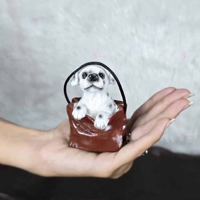 1 pc Cute Miniature Dog in Bag Poly Resin Statue with Hanging, Decorative Piece for Living Room, Bed Room, Table top, Restaurant, cafes, Gifting, Birthday( Pack of 1)